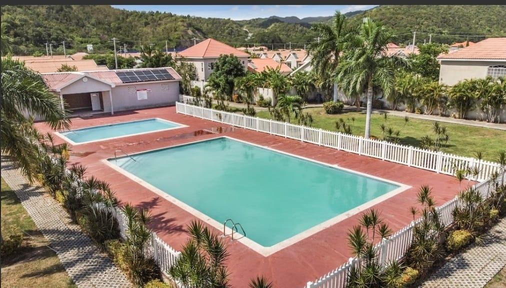 Community pool and amenities at Caymanas Estate